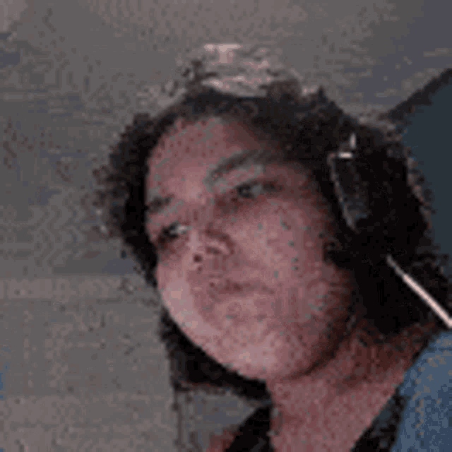a close up of a person wearing headphones and a microphone .
