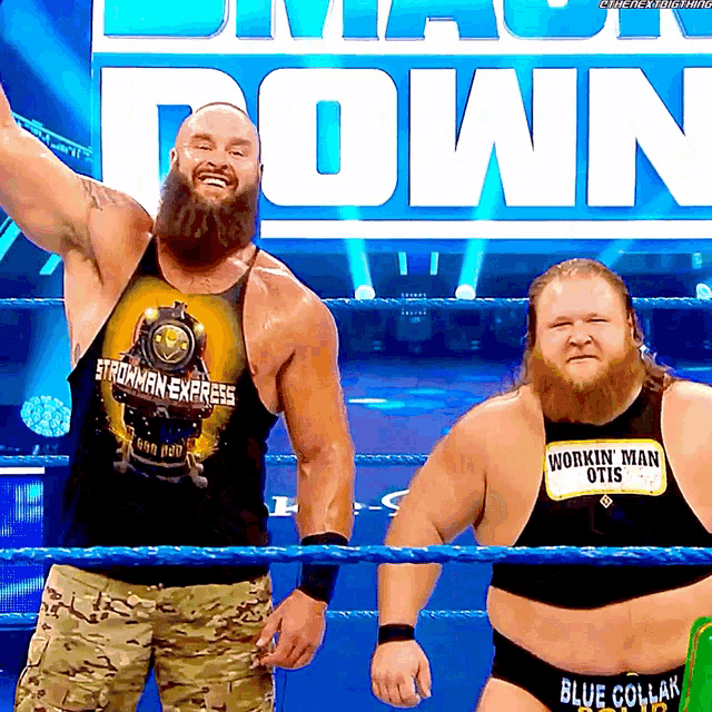 two men in a wrestling ring one wearing a shirt that says workin ' man otis