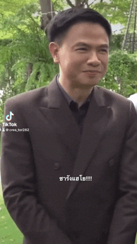 a man in a suit has tiktok written on the bottom of his screen