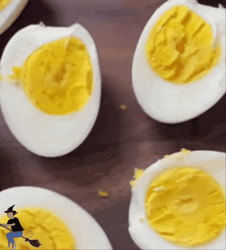 a witch is riding a broom next to hard boiled eggs on plates