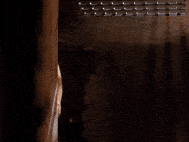 a woman in a dark room says come on this way in yellow letters