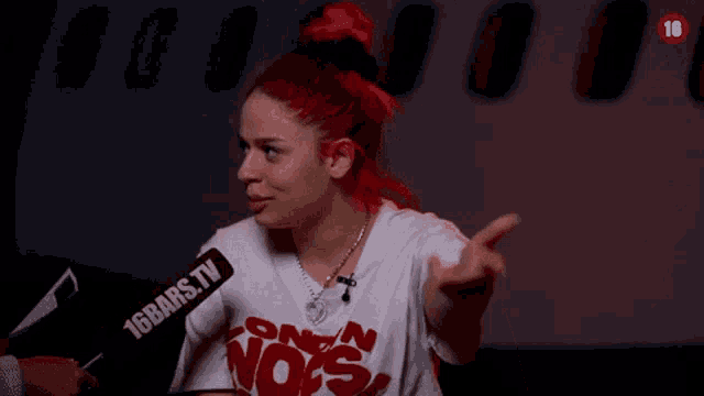 a woman with red hair is laughing in front of an airplane with the number 18 on it