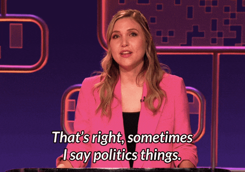 a woman in a pink jacket is talking about politics