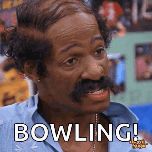 a man with a mustache says bowling in a bowling alley