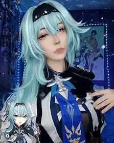 a woman wearing a blue wig and a blue and white outfit is standing in a room .