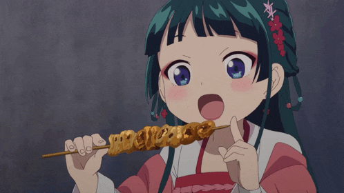 a girl with green hair and red flowers in her hair is eating a skewer of food