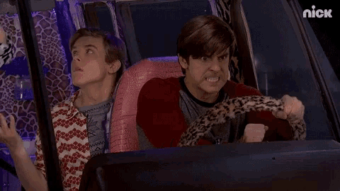 a man is driving a car with a leopard print seat cushion and another man is sitting in the back seat .