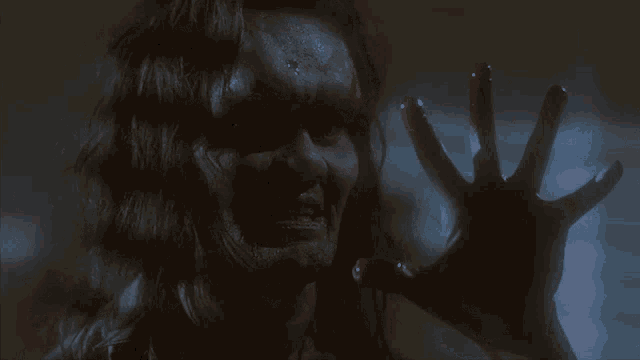 a close up of a man 's face with a knife in his hand