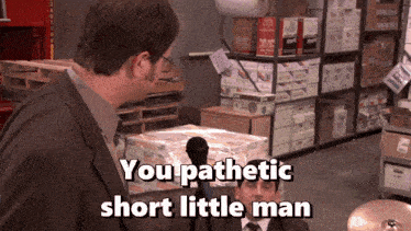 a man talking into a microphone with the words you pathetic short little man