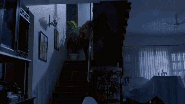 a dark room with a staircase leading up to the top