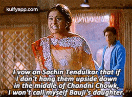 a woman in a sari is talking to a man in a blue jacket in a movie .
