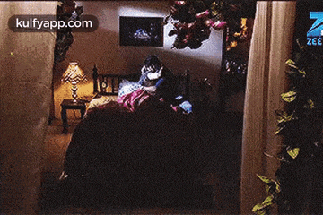 a man and woman are kissing on a bed with a watch on their wrist .