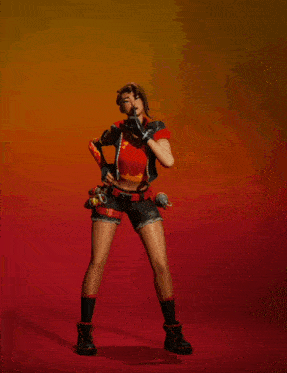 a woman in a red top and black shorts is holding a circle in her hand
