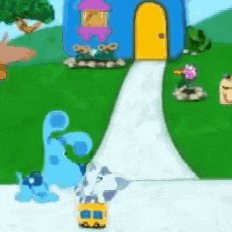 a blue dog is standing on the sidewalk in front of a blue house .