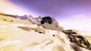 a car is flying through the air over a desert landscape