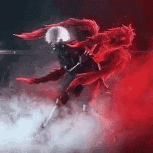 a person with red wings is standing in a foggy room with red smoke coming out of it .