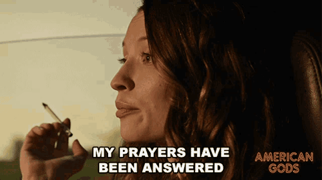 a woman smoking a cigarette in a car with the caption " my prayers have been answered "