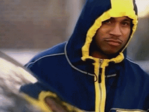 a man in a blue and yellow jacket with a hood