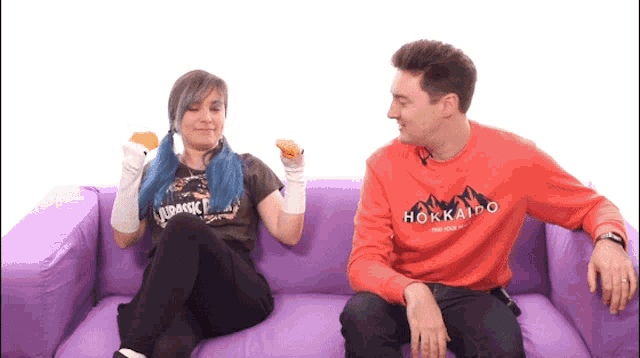 a man in a hokkaido sweatshirt sits next to a woman