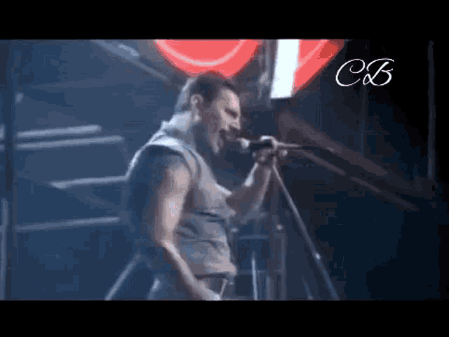 a man singing into a microphone on a stage .