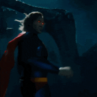 a man in a superman costume has a red and yellow s on his chest