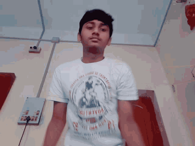 a young man wearing a t-shirt that says ' retest gwa doha ' on it