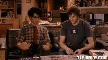 two men are sitting on a couch with a gifwave.com watermark