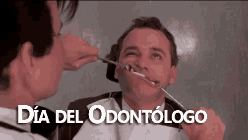 a man is getting his teeth examined by a dentist and the words dia del odontologo are written below him
