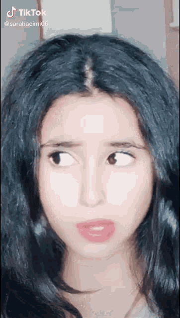 a close up of a woman 's face with a tiktok watermark on it
