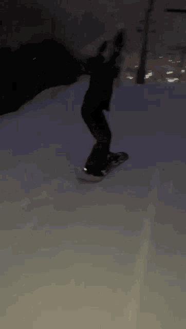 a person is riding a snowboard down a snowy hill