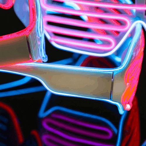 a close up of a colorful neon sign that looks like a skeleton