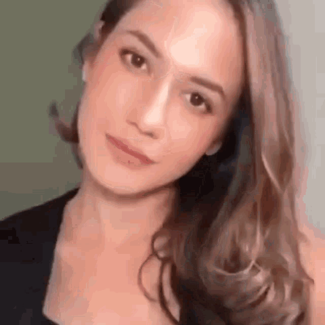 a close up of a woman 's face with long hair .