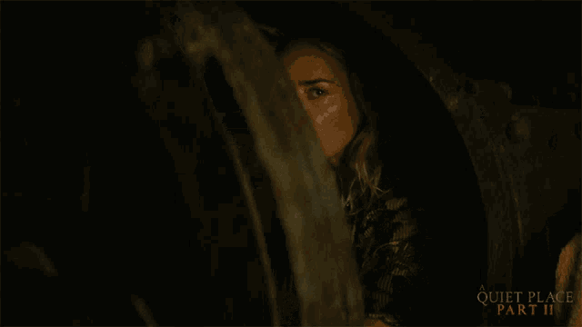 a poster for quiet place part ii shows a woman looking at a man