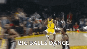 a basketball player is jumping in the air while dribbling the ball on a basketball court .