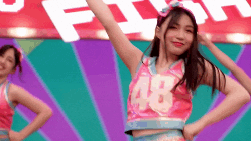 a cheerleader with the number 48 on her shirt