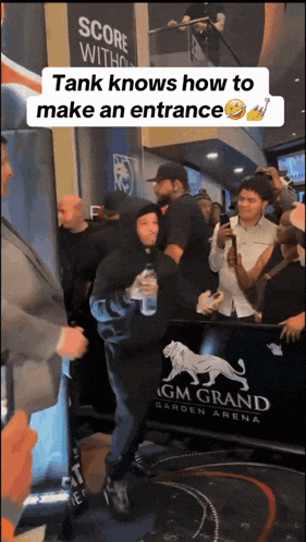 a man in a black hoodie stands in front of a sign that says mgm grand