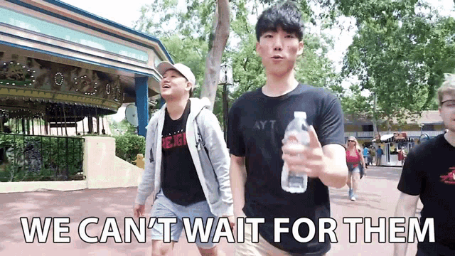 a man holding a water bottle with the words we can 't wait for them behind him