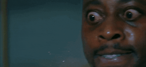 a close up of a man 's face with water coming out of his mouth and nose .