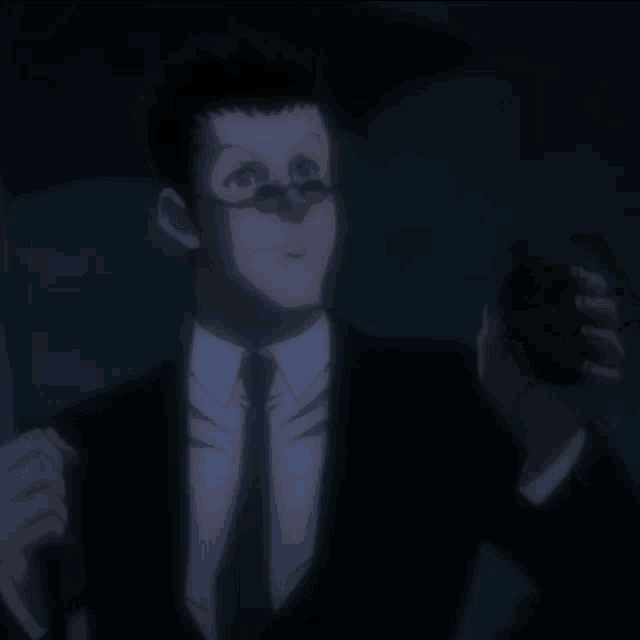a man in a suit and tie holding an umbrella