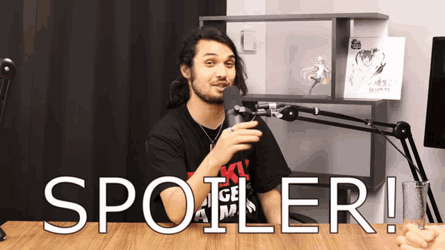 a man speaking into a microphone with the words spoiler written in white