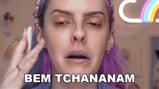a woman with purple hair has the words bem tchananam written on her face
