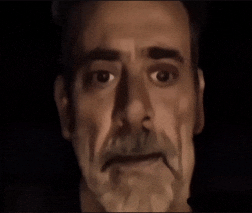 a close up of a man 's face with a beard and mustache