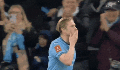 a soccer player in a blue jersey with a sticker on his chest that says ' fc barcelona '