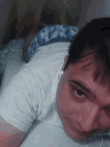 a man wearing headphones is laying down on his back