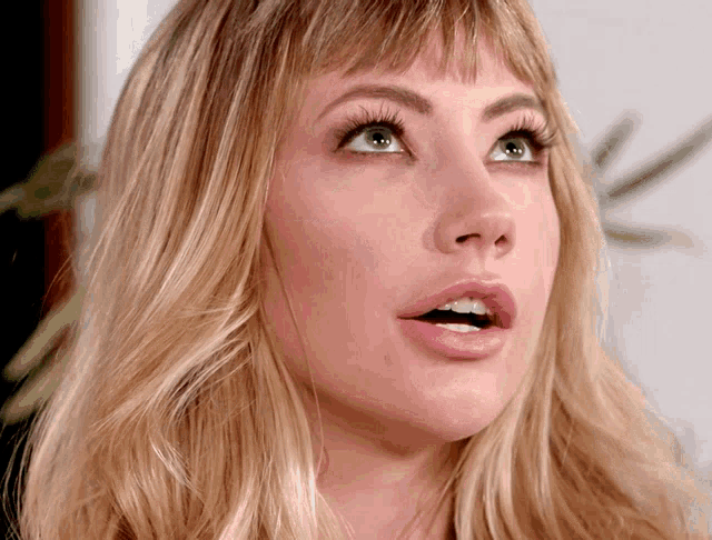 a close up of a woman with her mouth open