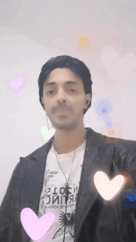 a man wearing a black jacket and a white shirt that says ' exotic '