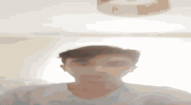 a man is standing in front of a mirror and looking at himself .