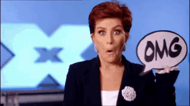 a woman is holding a speech bubble that says " omg "