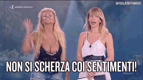 two women are standing next to each other with the words non si scherza coi sentimenti on the screen .