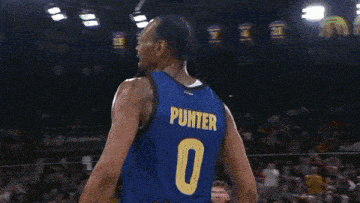 a basketball player stands in front of a scoreboard that shows the time as 9:39